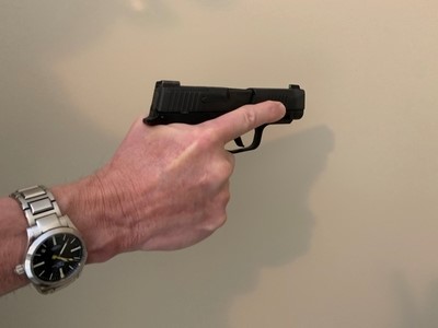 Finger held on slide of gun