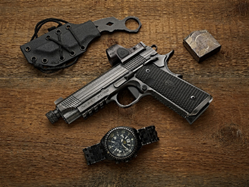 Firearm on table with knife and watch