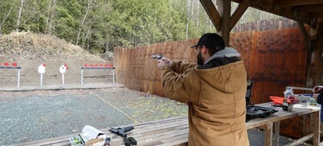 A senior man at the shooting range practicing hitting targets