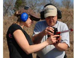 Karl instructs a student on how to grip the pistol